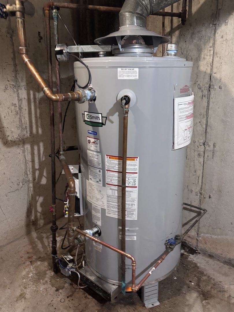 A.O. Smith 80 gallon natural gas water heater installed with new copper piping in an apartment building basement